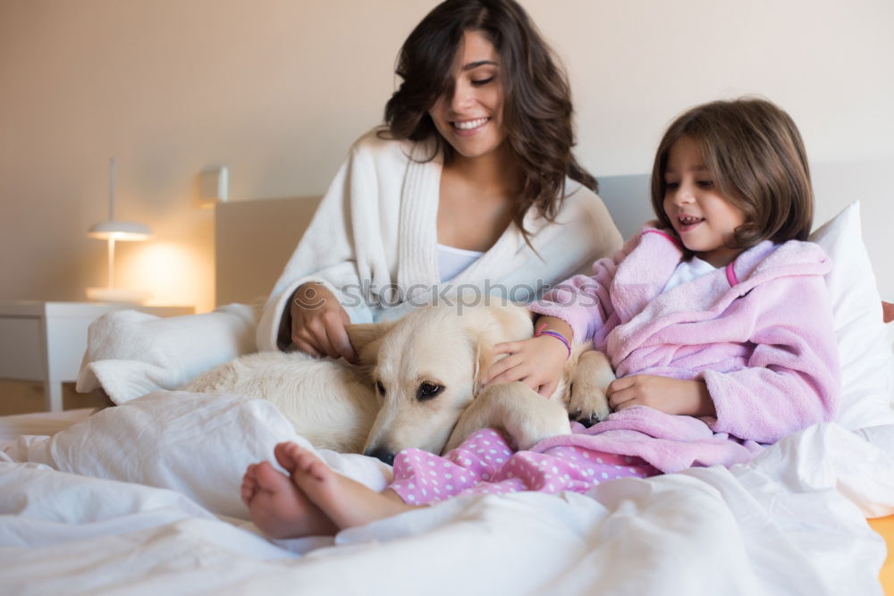 Similar – Couple relaxed at home in bed with their little daughter and the dog