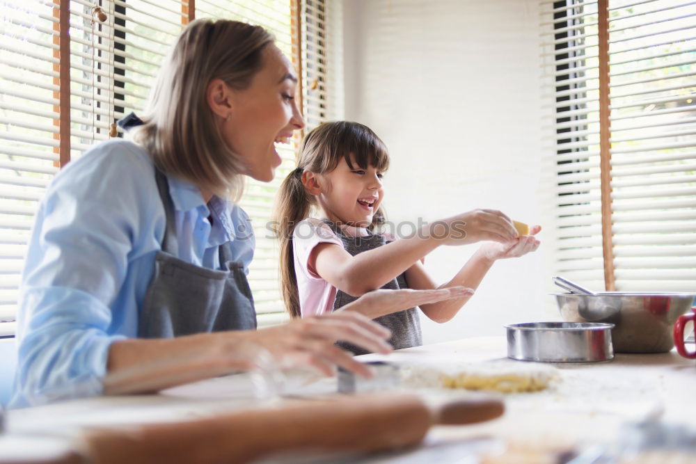 Similar – Image, Stock Photo Little sisters cooking with her mother in the kitchen.