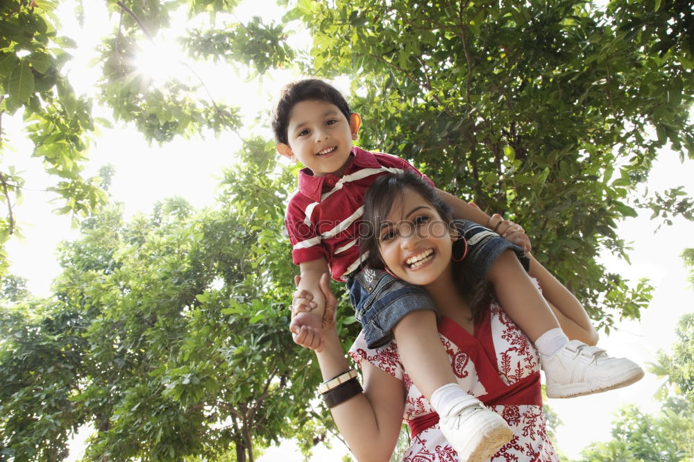 Similar – Image, Stock Photo Muslim mother holding a little baby by arms in outdoor area