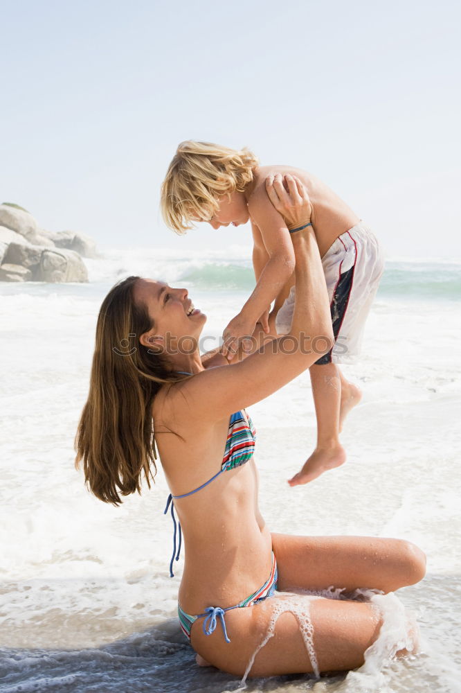 Similar – Image, Stock Photo Mother and toddler son playing with toys at beach