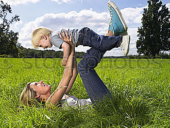 Similar – Image, Stock Photo Mother and daughter doing yoga exercises on grass in the park at the day time