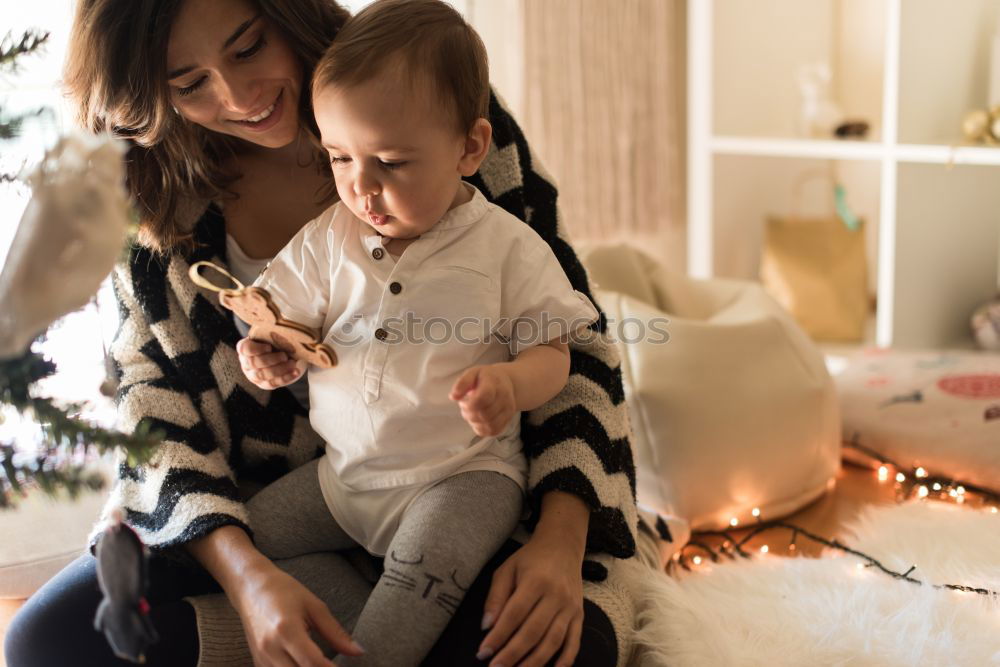 Similar – Image, Stock Photo Mother and son putting christmas costume on