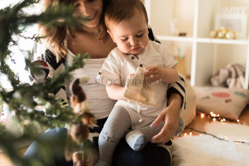 Similar – Image, Stock Photo Mother and son putting christmas costume on