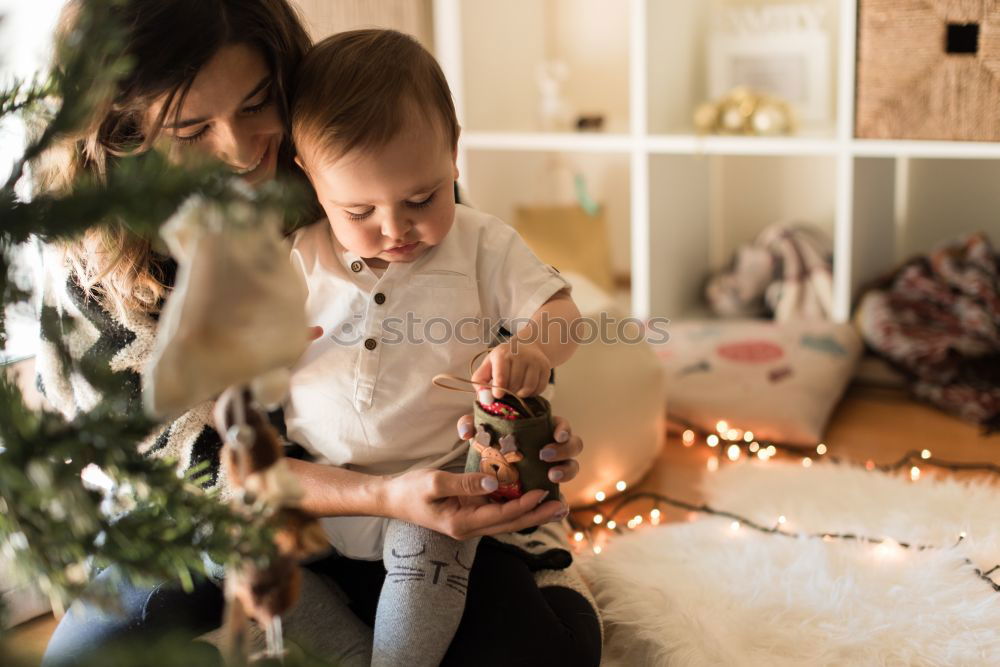 Similar – Image, Stock Photo Mother and son putting christmas costume on