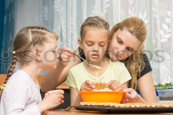 Similar – Family decorating baked Christmas gingerbread cookies with frosting