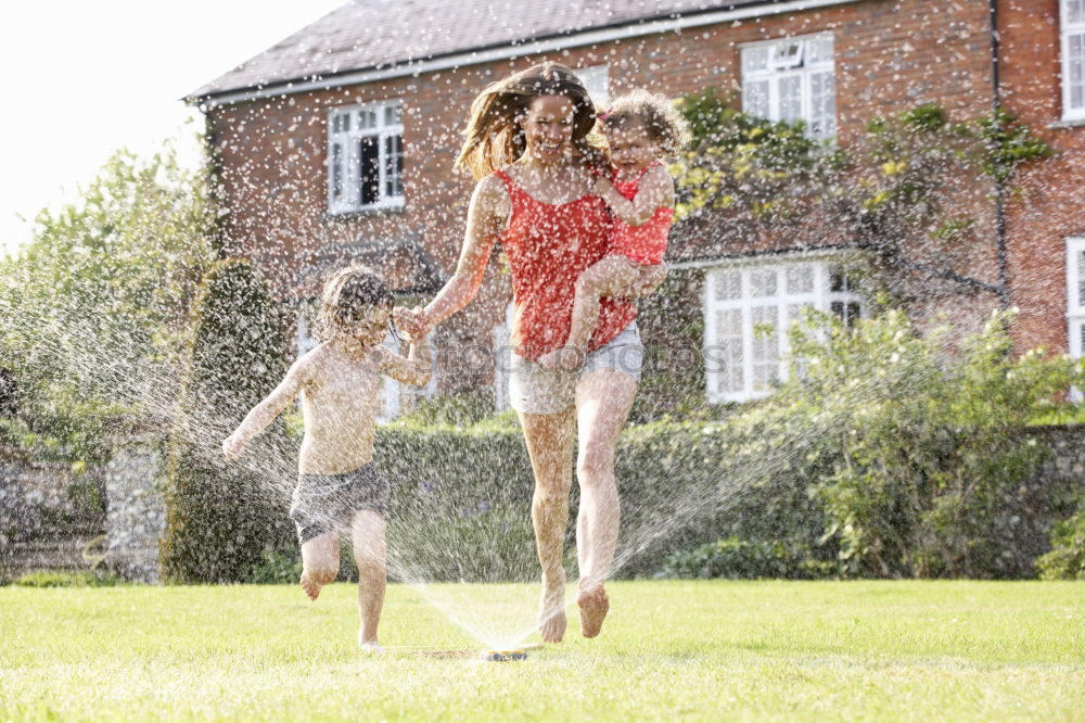 Similar – Teen girl spraying little sister in garden