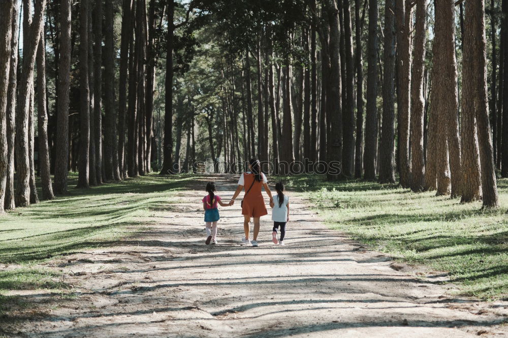 Similar – Retired couple walking their grandson on the path of a forest