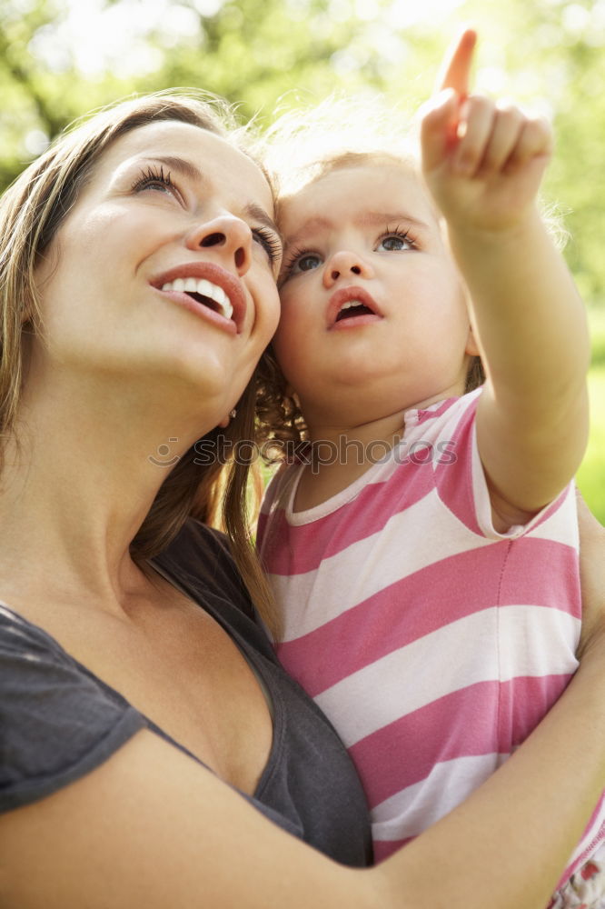 Similar – Image, Stock Photo Mother holding kid on hands in park