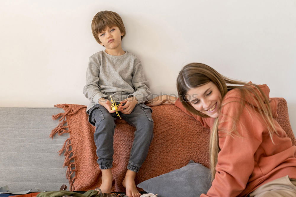 Similar – Girl and boy reading book sitting on bed