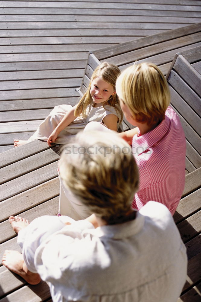 Similar – Family spending vacation time together having a snack sitting on jetty over the lake on sunny day in the summertime