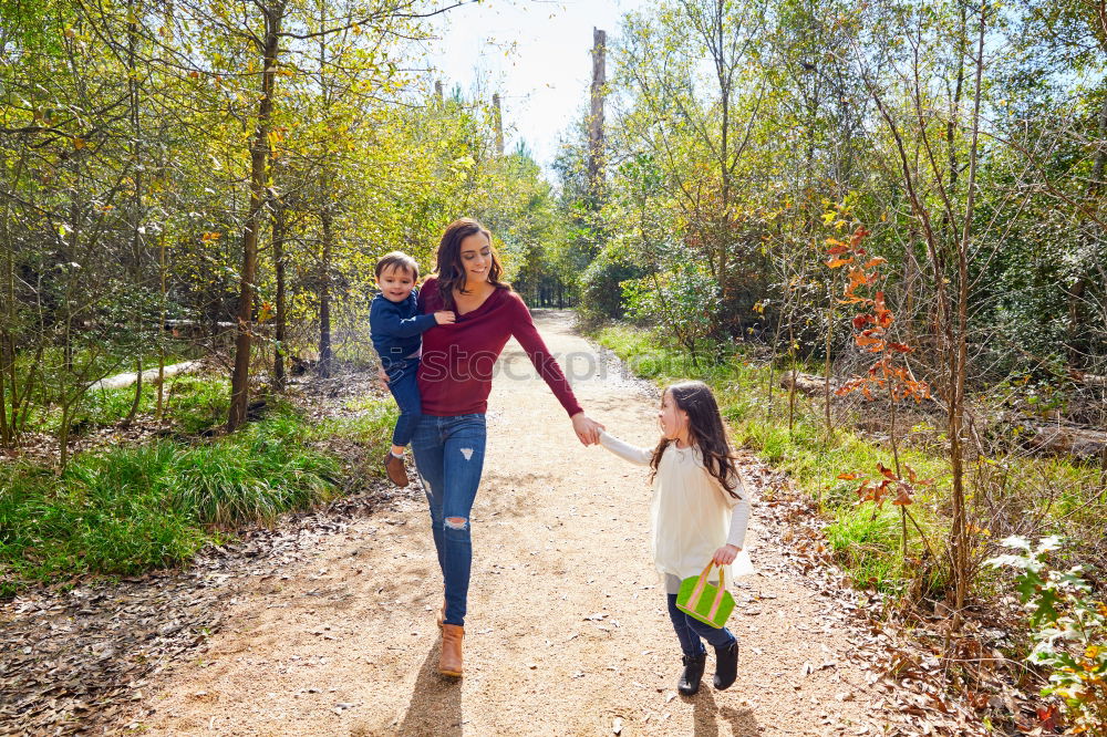 Similar – Happy family walking together holding hands in the forest