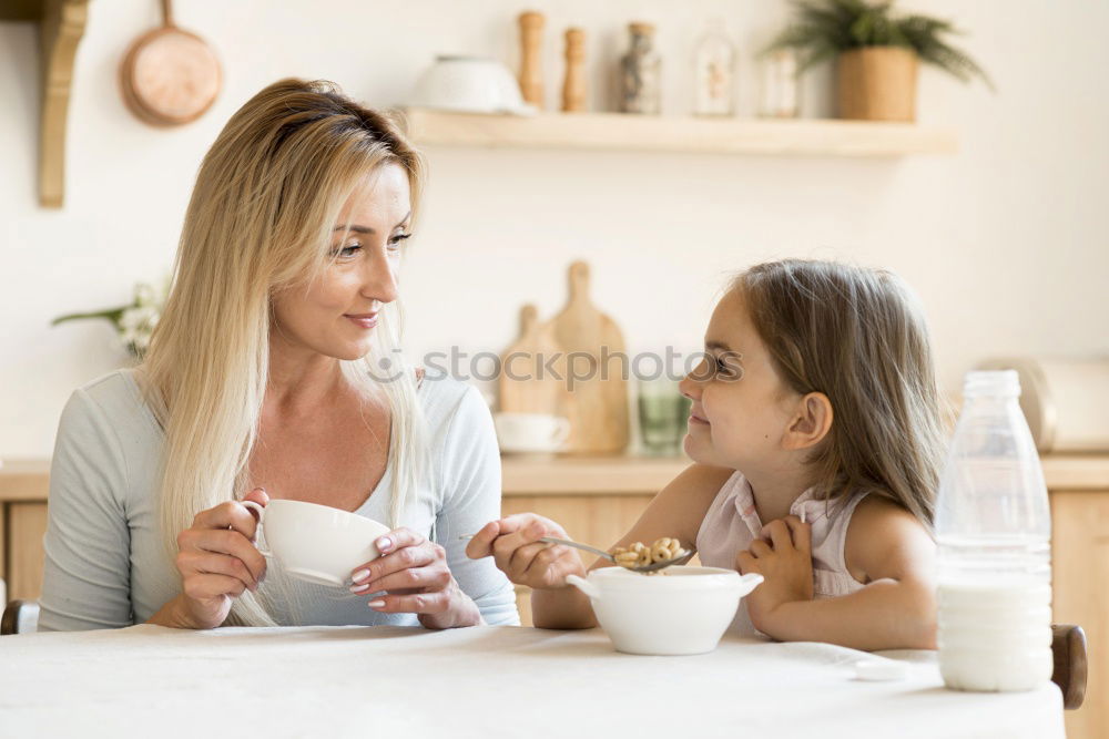 Similar – Image, Stock Photo Little sisters cooking with her mother in the kitchen.