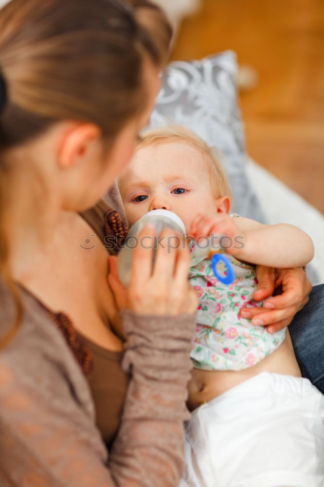 Similar – Image, Stock Photo Young mother breast feeding her baby at home
