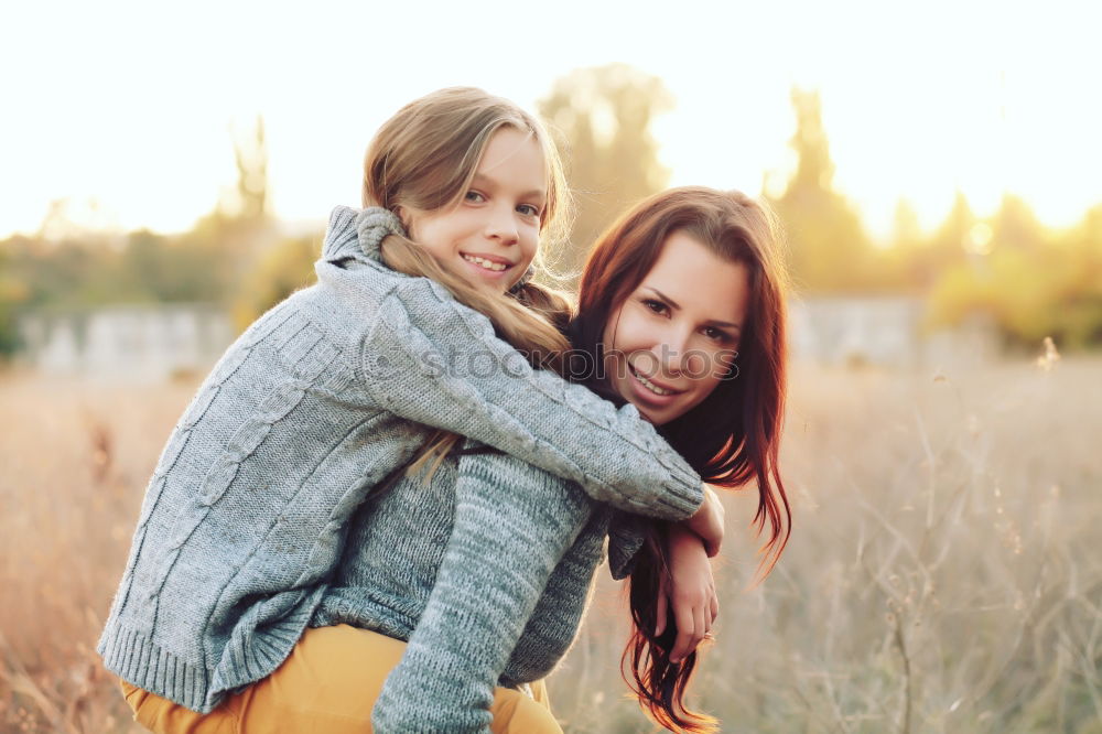 happy mother and daughter on the walk on summer