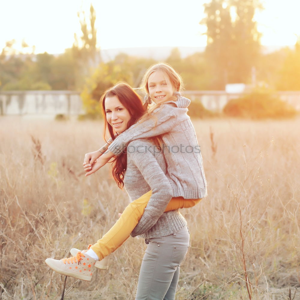 Similar – Two happy girls hugging in urban park.