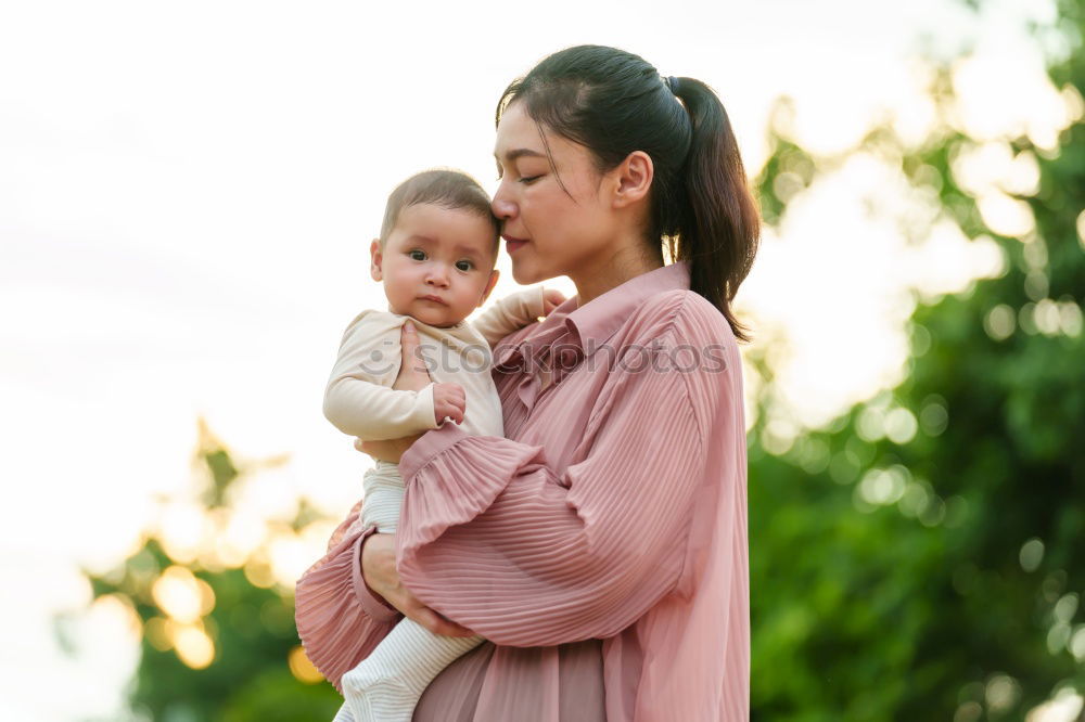 mother kissing little baby at bar terrace