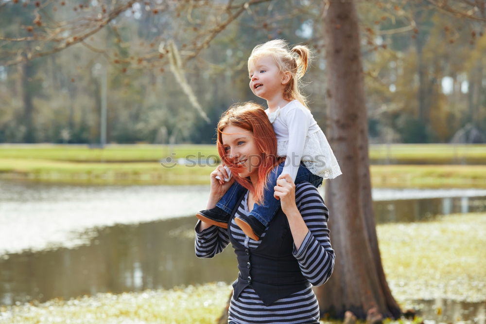 Similar – happy family: young mother walks with her child in the Park