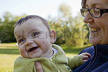 Similar – Image, Stock Photo Muslim mother holding a little baby by arms in outdoor area