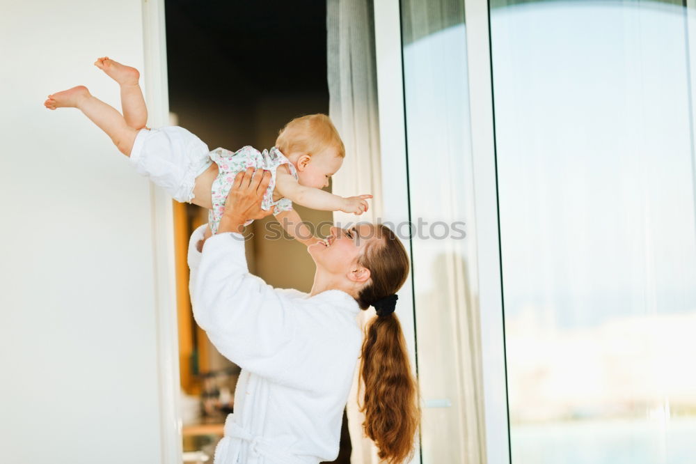 Similar – mother reading book to toddler daughter