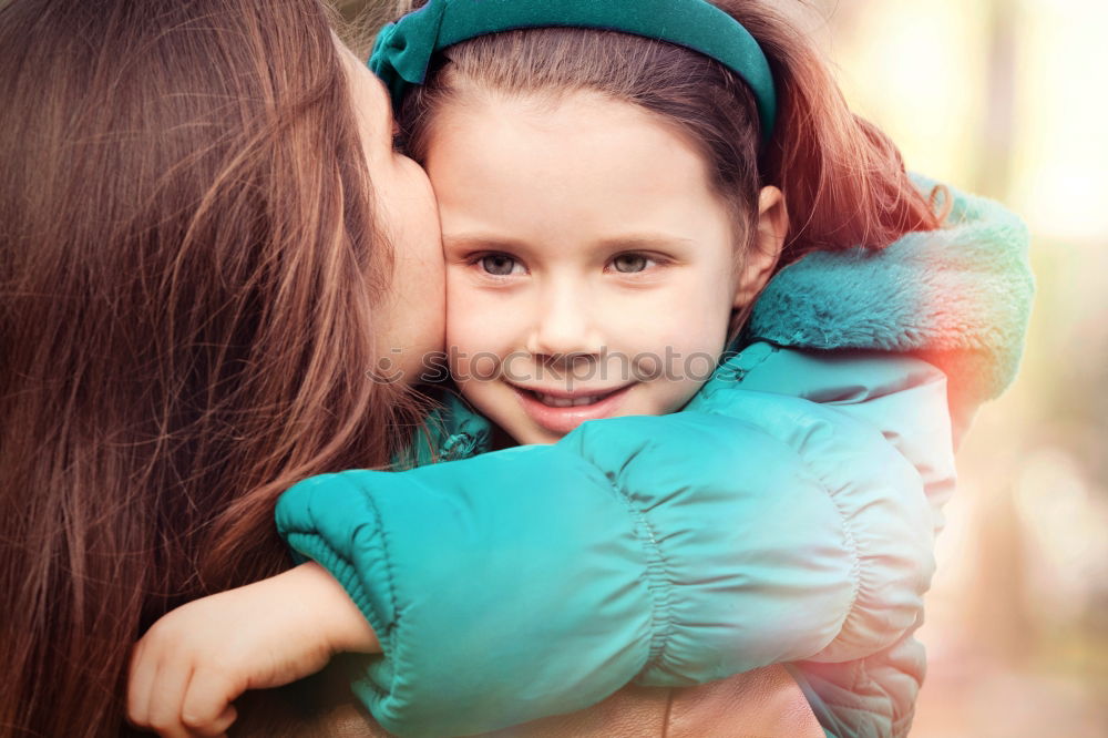 Similar – Adult woman holding a child eating a strawberry