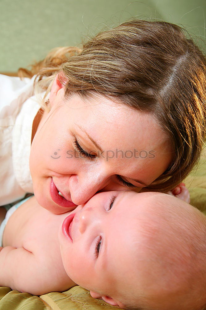 Similar – Woman playing with little happy baby on bed