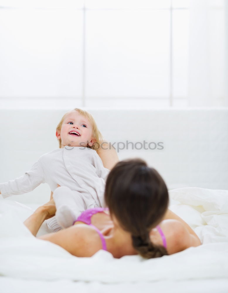 Similar – Two beautiful sisters playing on bed