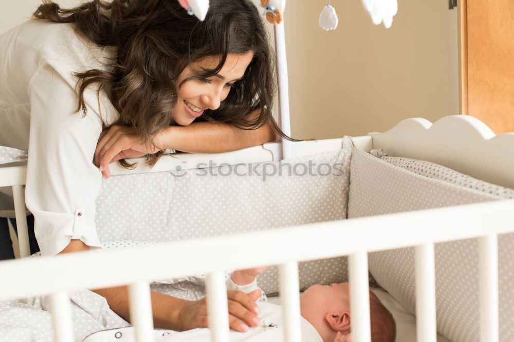 Similar – Image, Stock Photo Young mother holding her baby in the bedroom