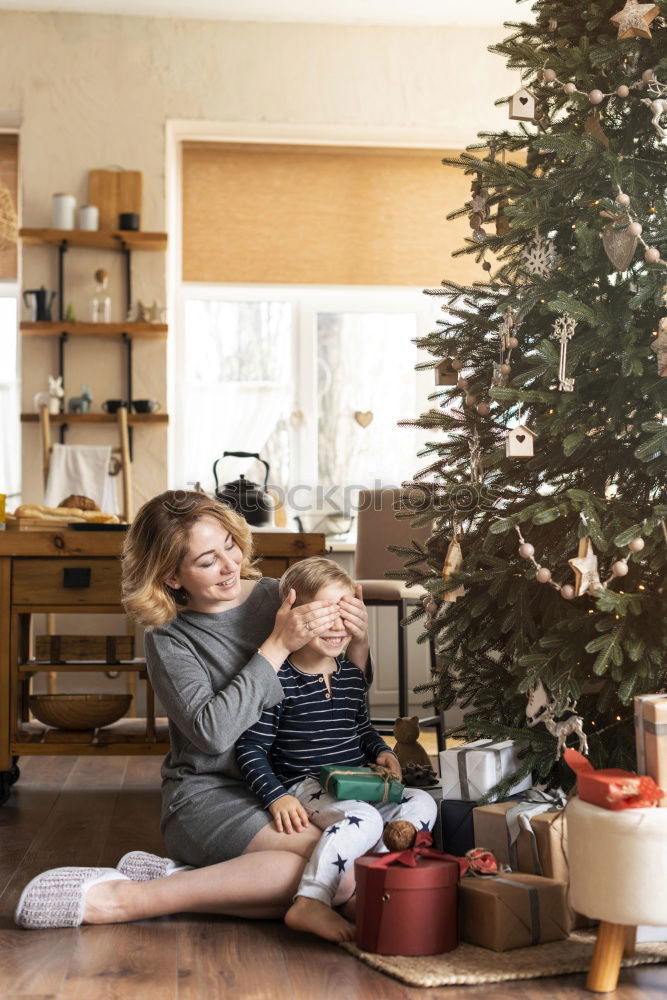 Similar – Image, Stock Photo Mother and son putting christmas costume on