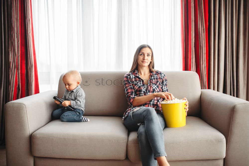 Similar – caucasian mother and son relaxing together on couch at home