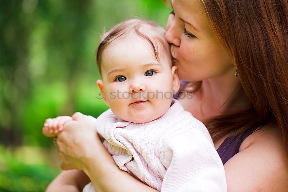 Similar – Image, Stock Photo Back view of mother holding baby girl in her arms