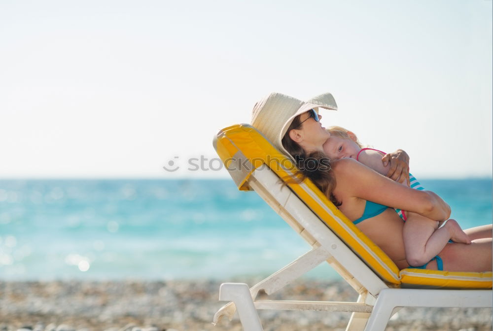 Similar – Image, Stock Photo Mother, father and little son on summer vacation at the seaside, They wearing snorkels and flippers while lying and playing on the beach