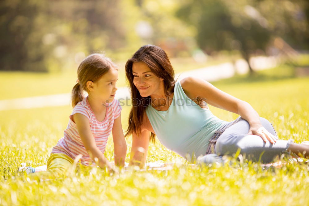 mother and little girl playing in the park