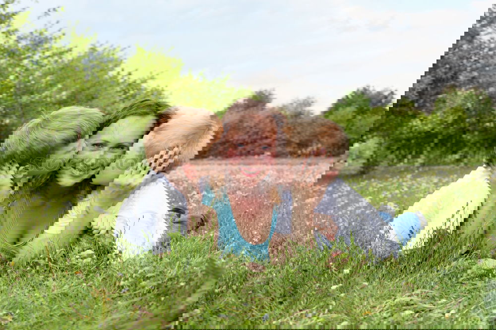 Similar – Image, Stock Photo Young mother forms heart with her children in the high grass