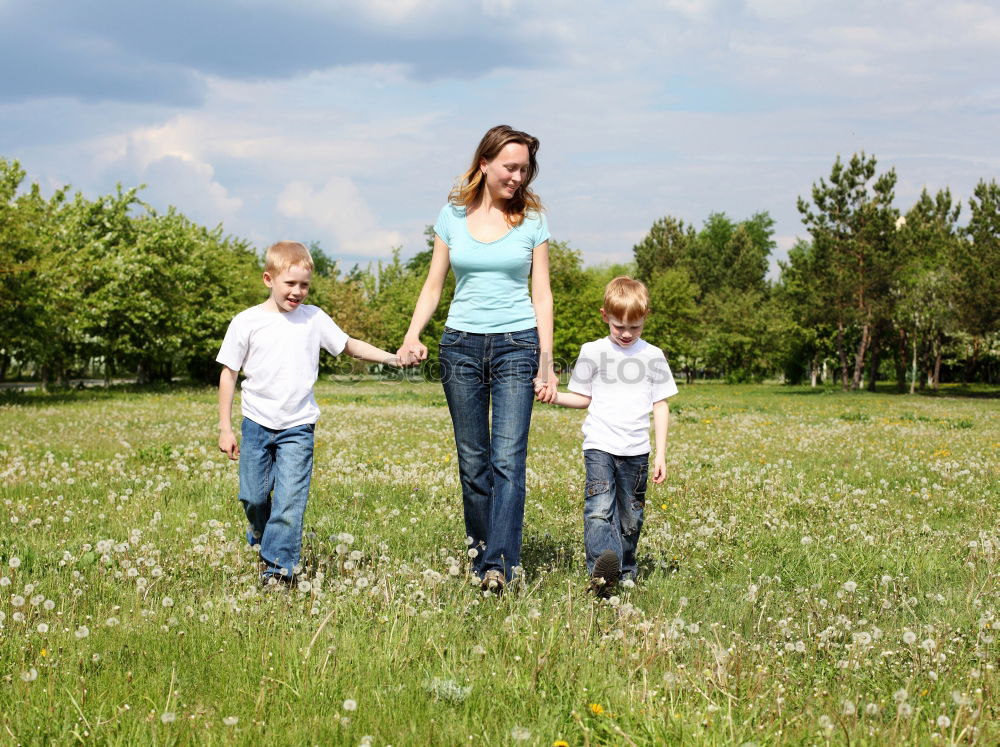 Similar – happy family of four hand in hand on the field