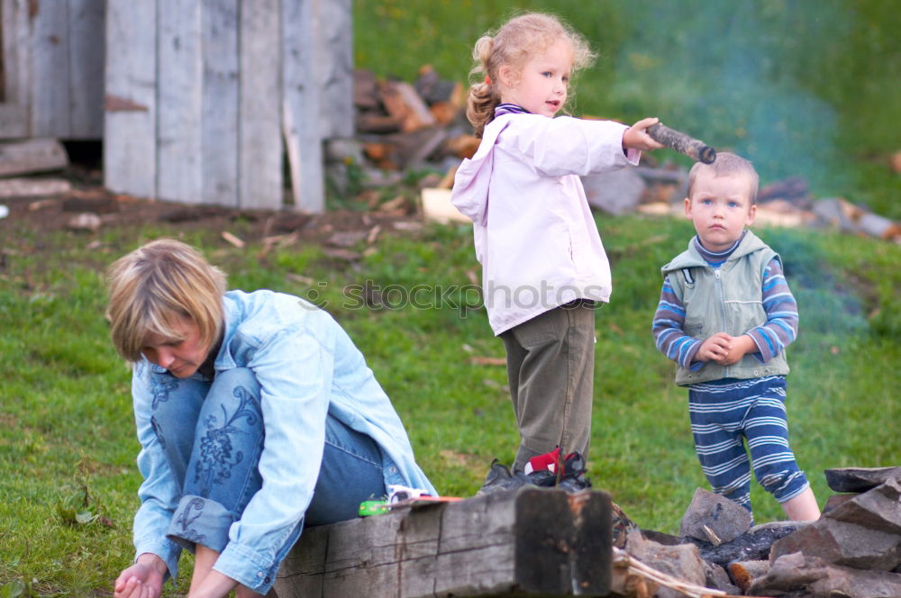 Image, Stock Photo Man and his little daughter having barbecue in forest on rocky shore of lake, making a fire, grilling bread, vegetables and marshmallow. Family exploring Finland. Scandinavian summer landscape.