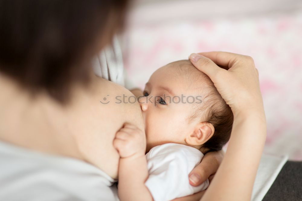 Similar – Image, Stock Photo Young mother breast feeding her baby at home