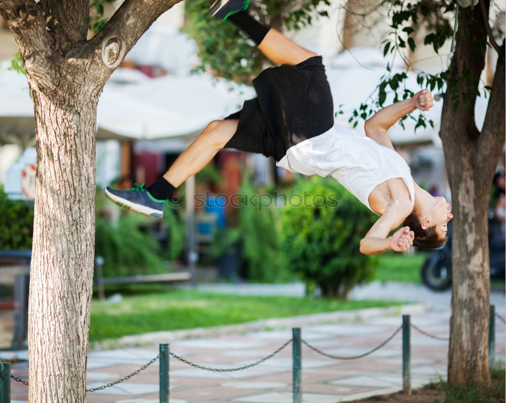 Motion shot of a young sportsman doing acrobatics in the city. Front flip trick