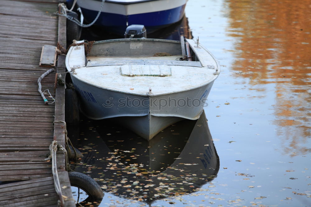 Similar – Spiegelung der Unterseite eines Fischerbootes im Abendlicht