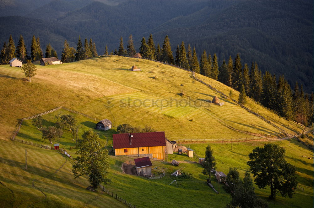 Similar – Mountains village on hillsides. Lone house on green hills