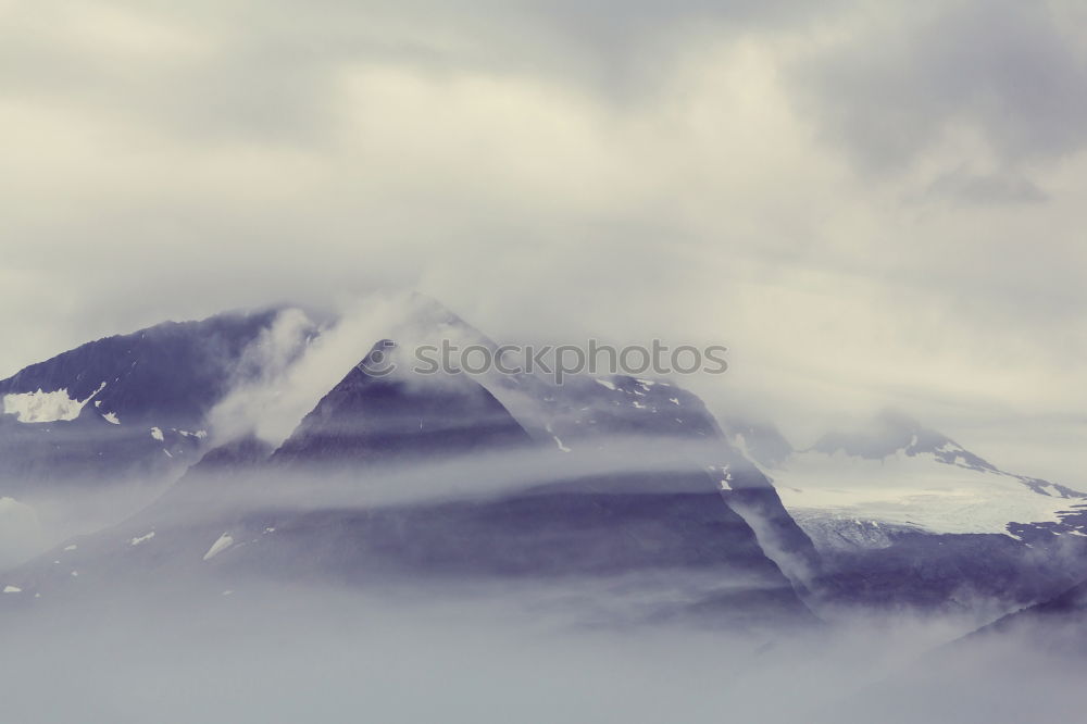 Similar – Panorama of forest covered by low clouds. Autumn rain and fog