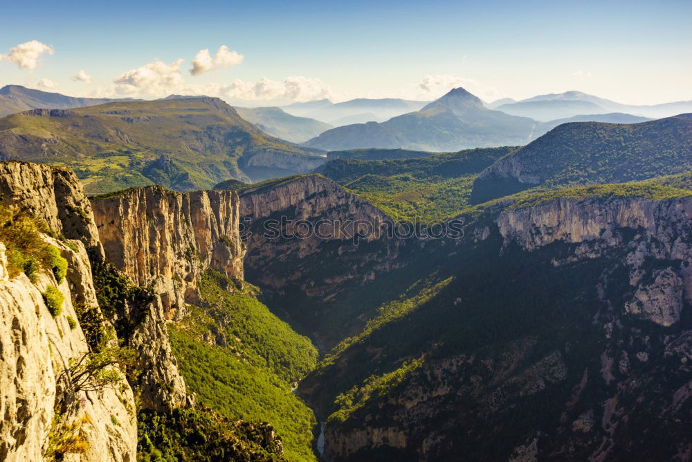 Similar – A vast expanse of fields and mountains full of trees taken from the top of a cliff