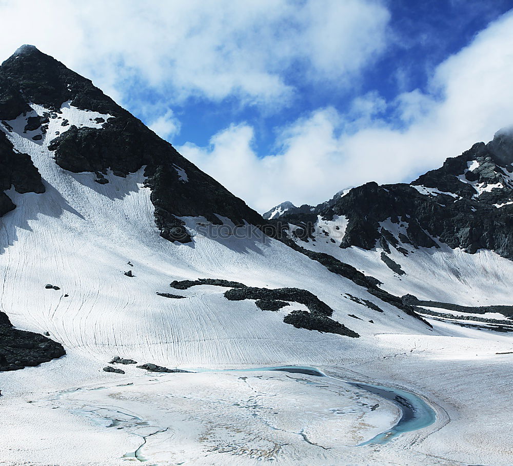 Similar – Man walking in snowy mountains