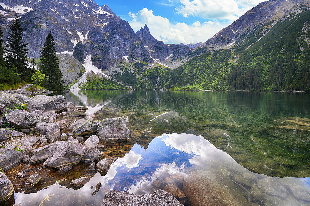 Similar – snowy mountain lake with mountains and blue sky