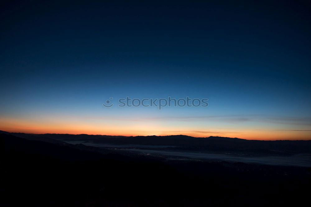 Similar – Mountain silhouette in sunset