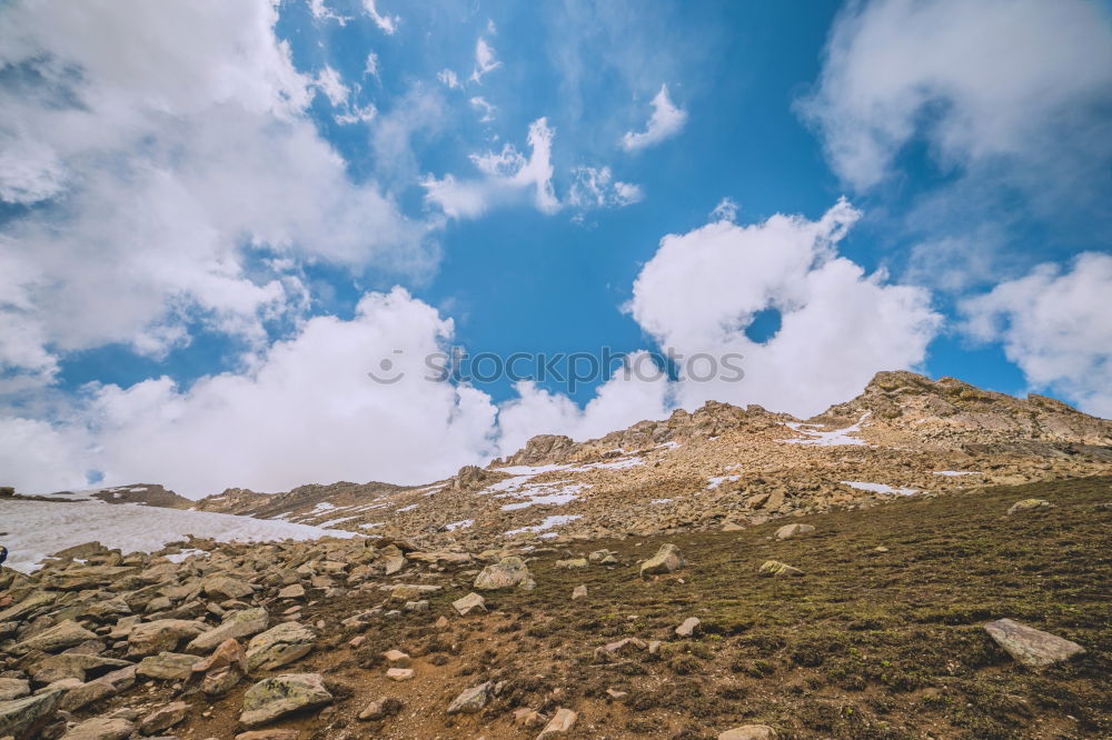 Similar – female hiker going up a mountain with snow.