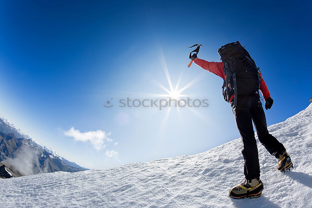 Similar – Image, Stock Photo Mountaineer faces a climb at the top of a snowy peak.