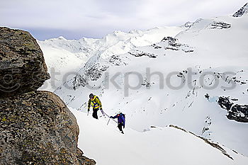 Similar – Female climber in the storm during an extreme winter climb