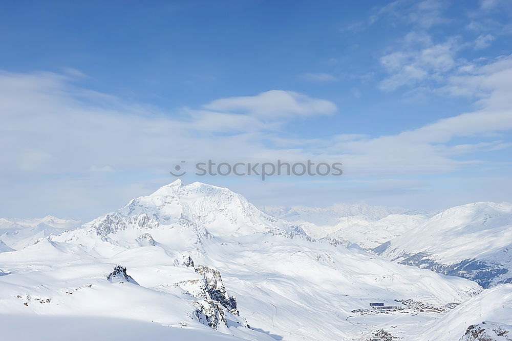 Similar – Snowy blue mountains in clouds at sunset