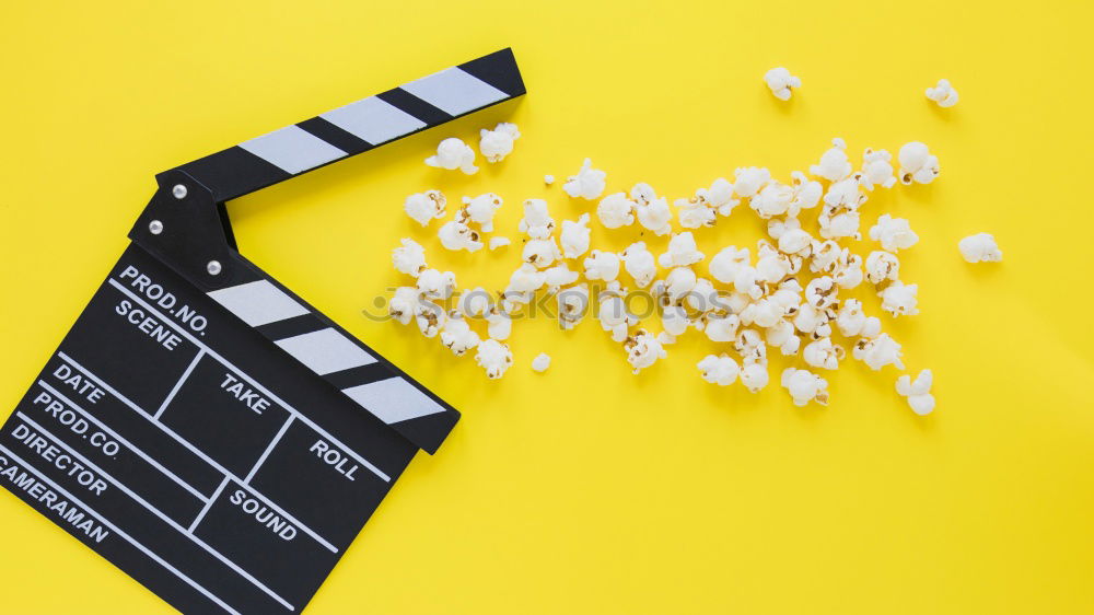 Similar – popcorn and clapboard on yellow background. Cinema concept