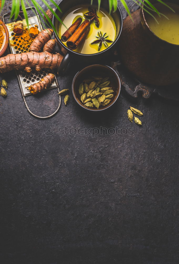 Image, Stock Photo Mug of healthy turmeric milk drink with ingredients: fresh turmeric roots , spices and honey on dark background, top view.  Hot winter beverage. Immune boosting remedy , detox and dieting concept